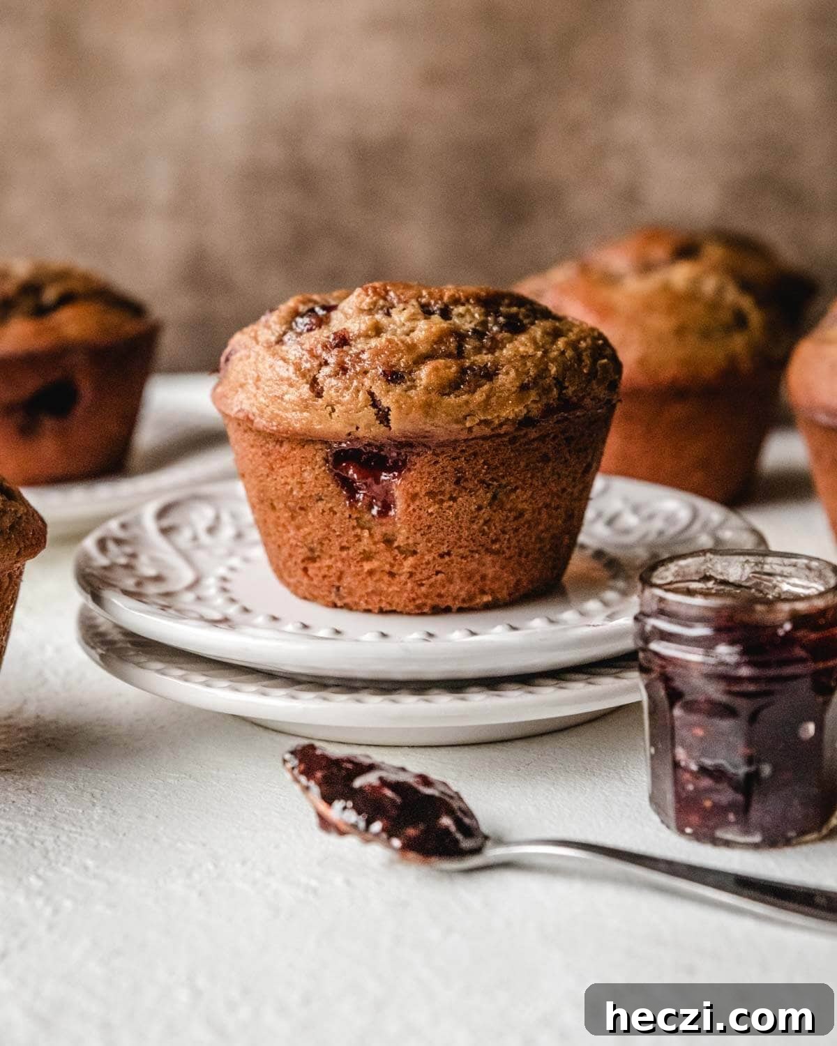 Quick Homemade Ricotta Cheese in Under 30 Minutes 24 Lemon ricotta muffin on two plates with raspberry jam in front.