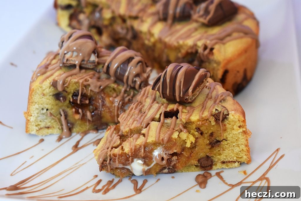 Kinder Bueno Cookie Pie Recipe — Hazelnut Chocolate Dessert Pie 10 Slice of chocolate drizzled cookie pie on a plate.