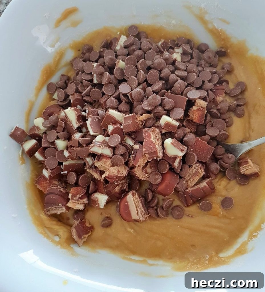 Kinder Bueno Cookie Pie Recipe — Hazelnut Chocolate Dessert Pie 7 Kinder Bueno added to cookie dough in a bowl.