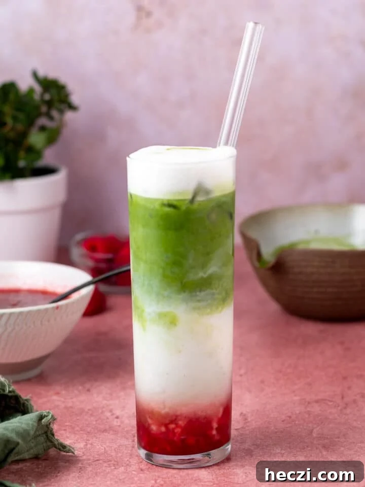 layered iced matcha latte with raspberry puree, oat milk and matcha green tea