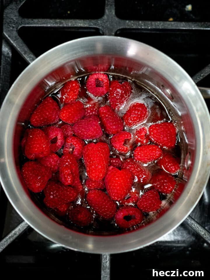 raspberries and honey in a saucepan