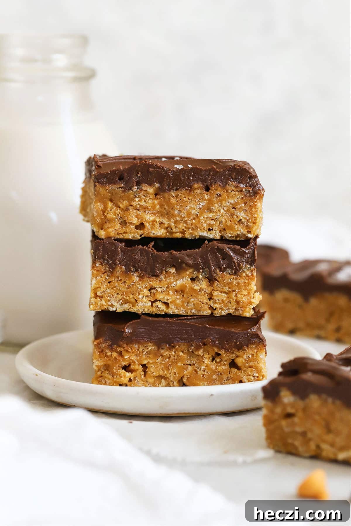 Gluten-Free Scotcheroos Recipe: Chewy Peanut Butter & Butterscotch Bars 2 three gluten-free scotcheroo squares stacked on a white dessert plate