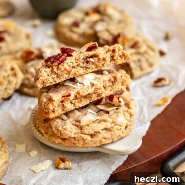 A stack of coconut pecan cookies. The top two are broken in half.