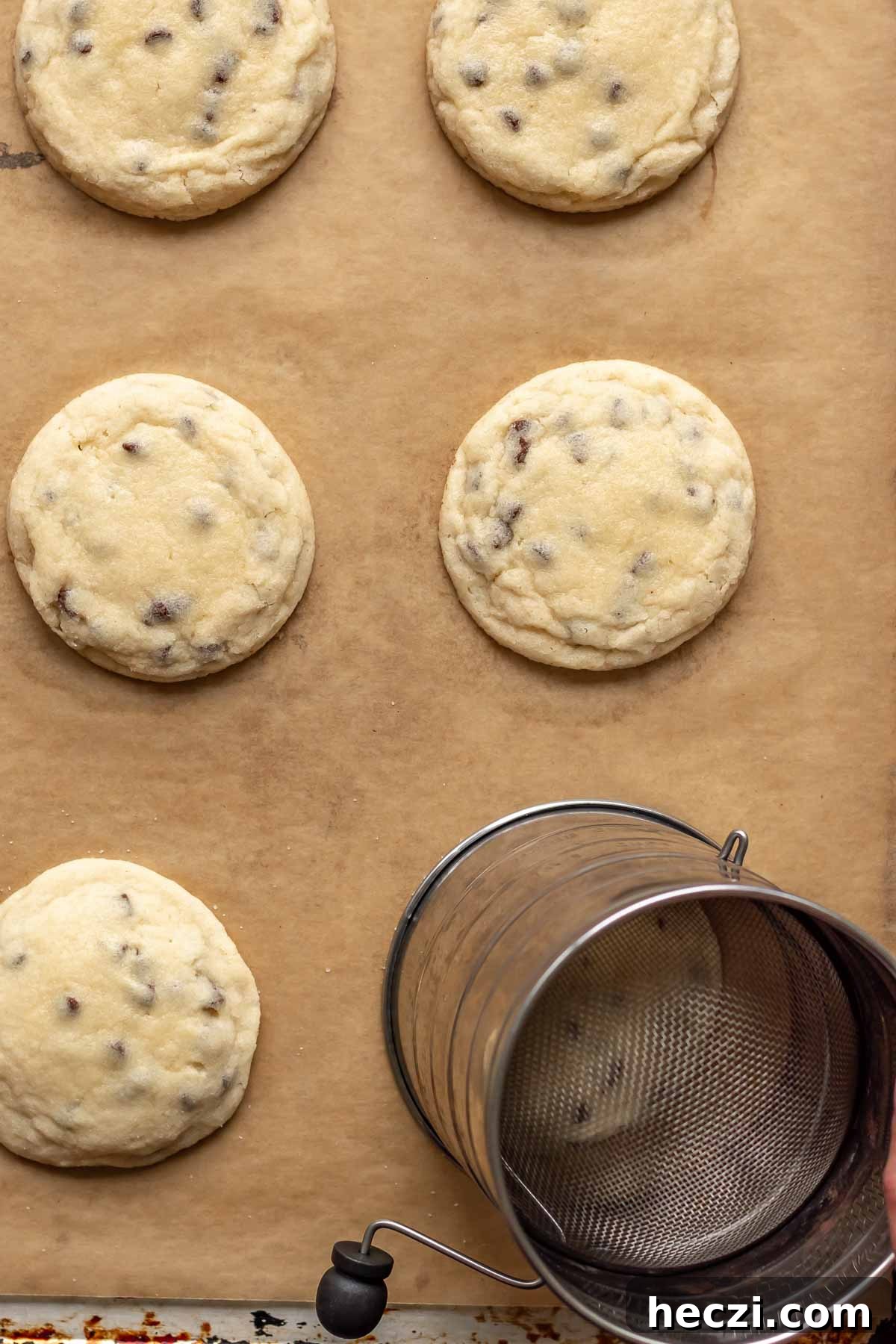A round object goes around one of the baked cookies to make it perfectly round.