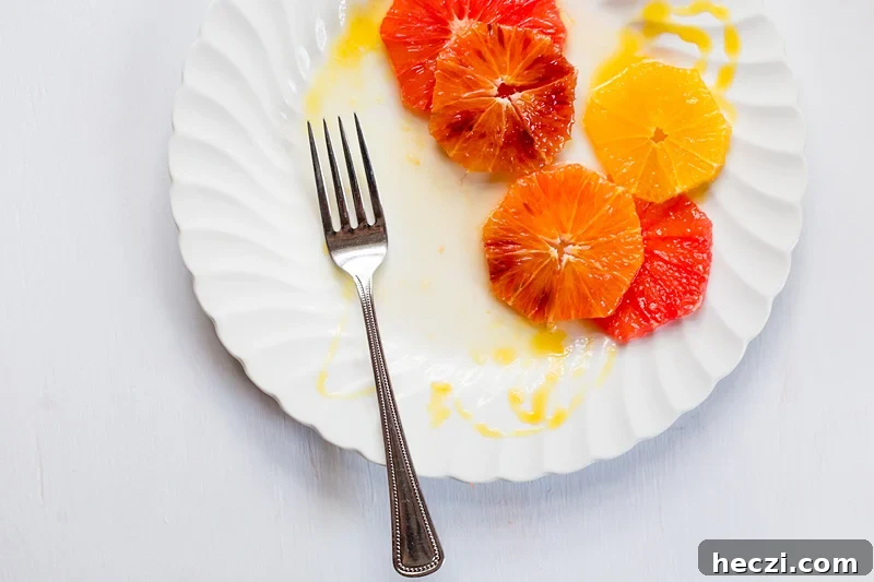 partially eaten citrus salad with a fork