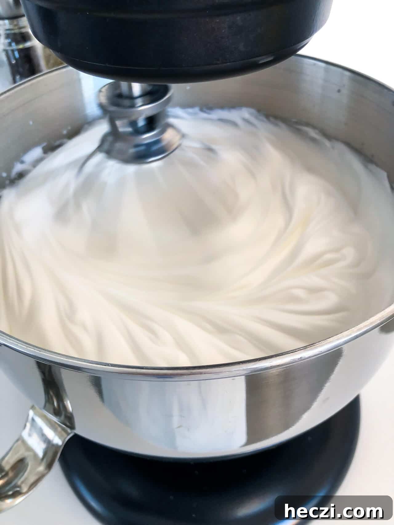 Whipping egg whites to stiff, glossy peaks like a pillowy meringue
