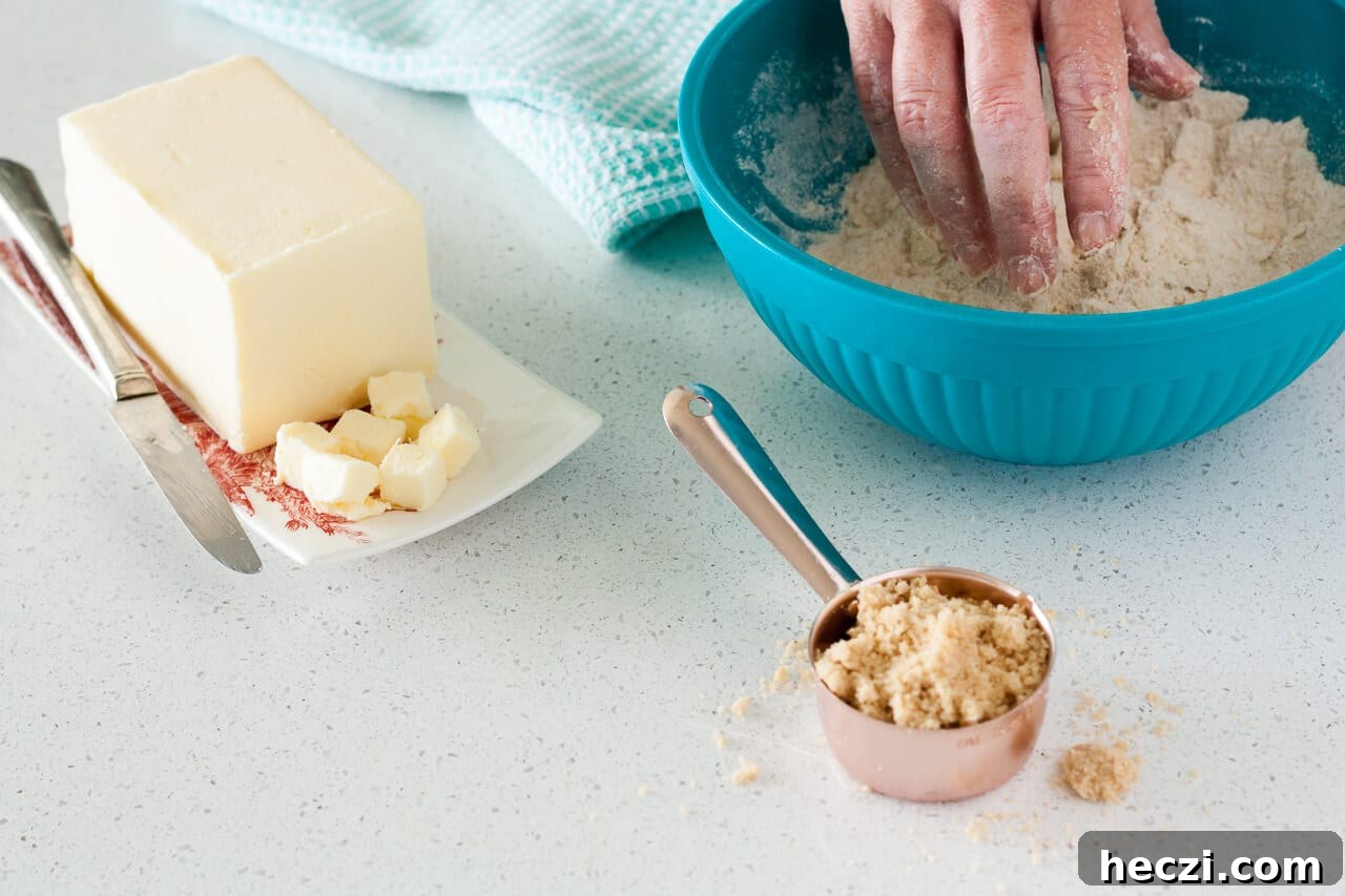 Making a crumble topping by hand with flour, butter, brown sugar
