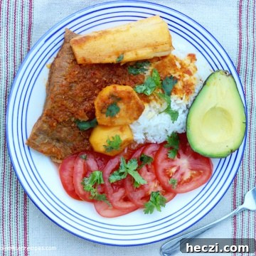 Sobrebarriga Sudada (Flan Steak Stew) over white rice with avocado, yuca and potatoes