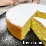 Sliced Torta Paradiso on a black plate.