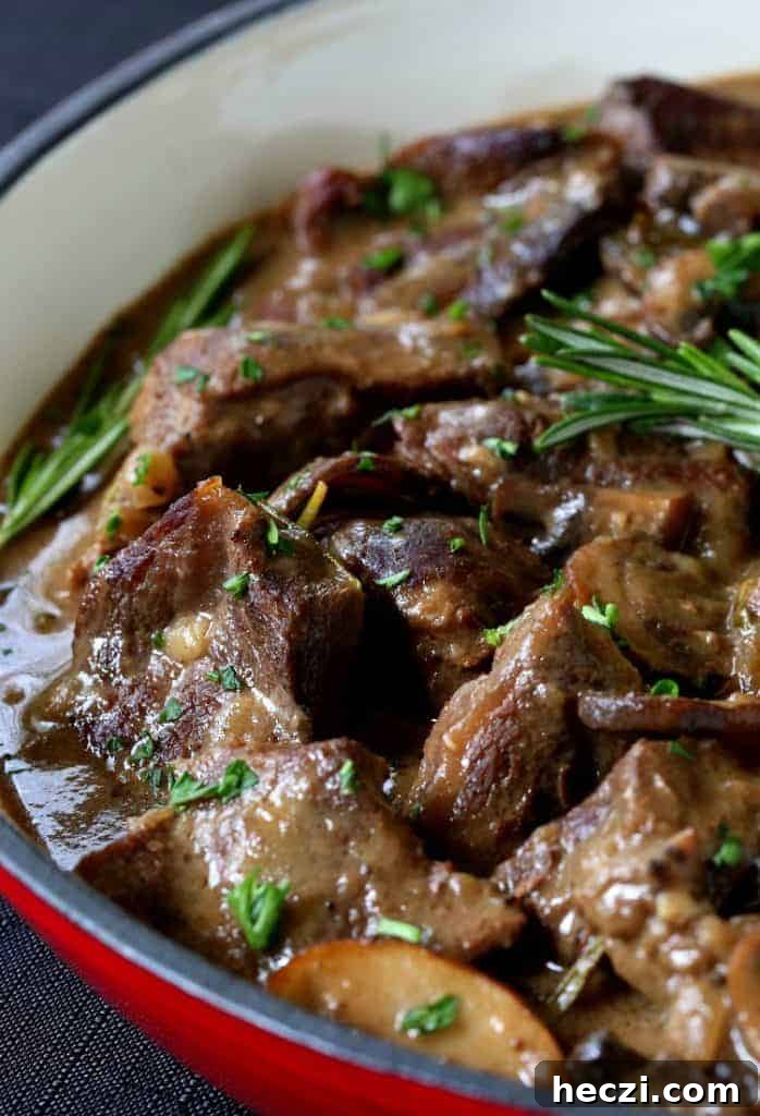 Marsala Braised Beef Steewith Mushrooms and Red Wine Sauce 6 Marsala Wine Beef Stew in a pot with gravy and fresh rosemary