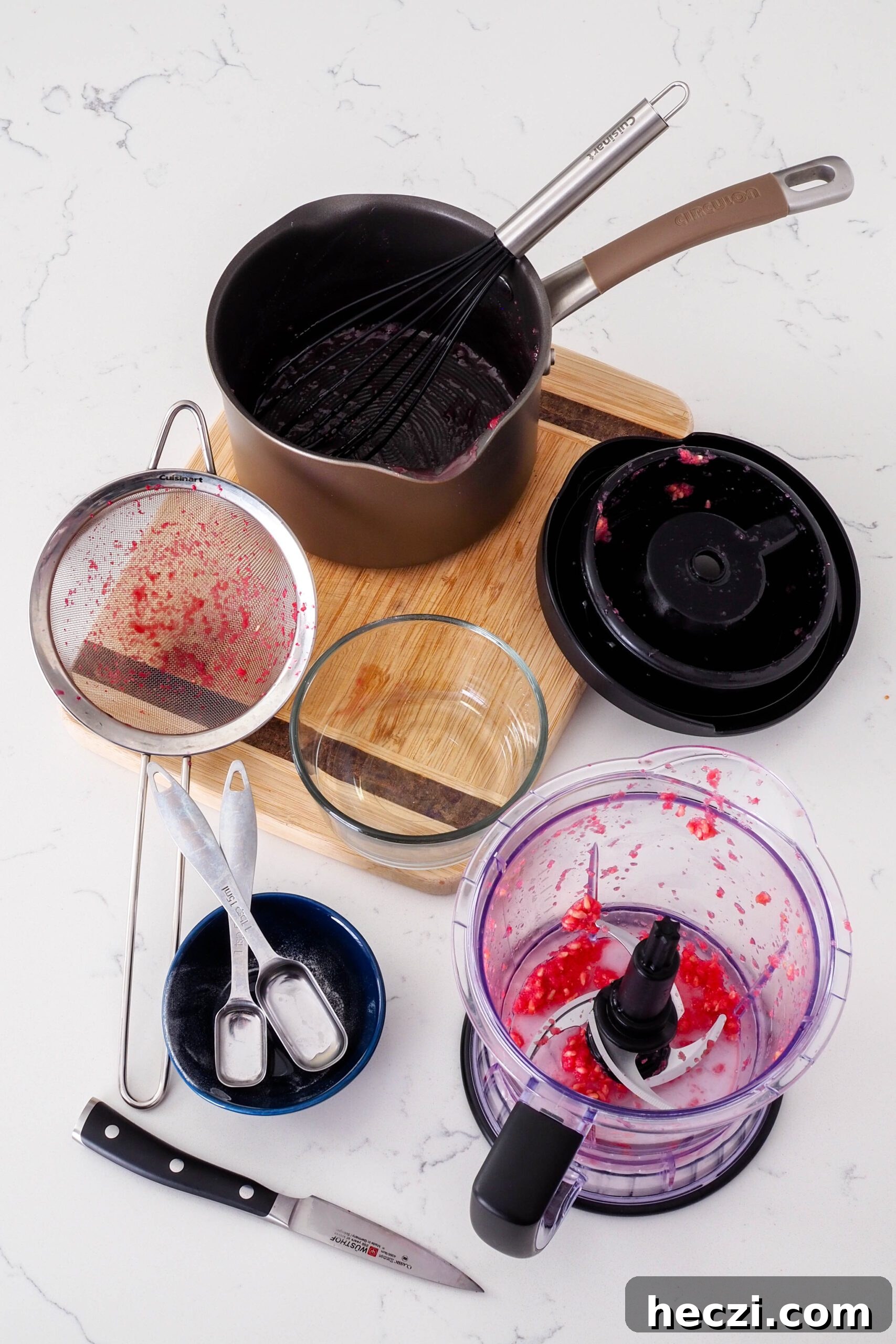 A collection of dishes used to make pomegranate jelly.
