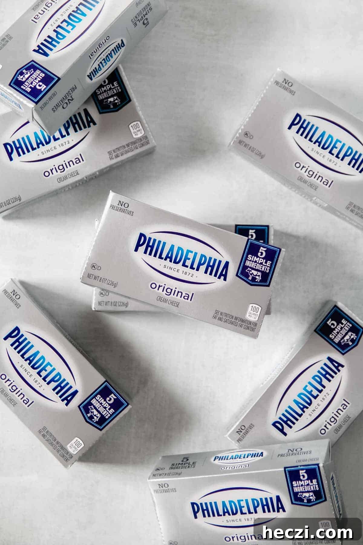 Is Philadelphia Cream Cheese Gluten-Free? What You Need to Know 3 Bricks of Philadelphia cream cheese scattered on concrete surface.