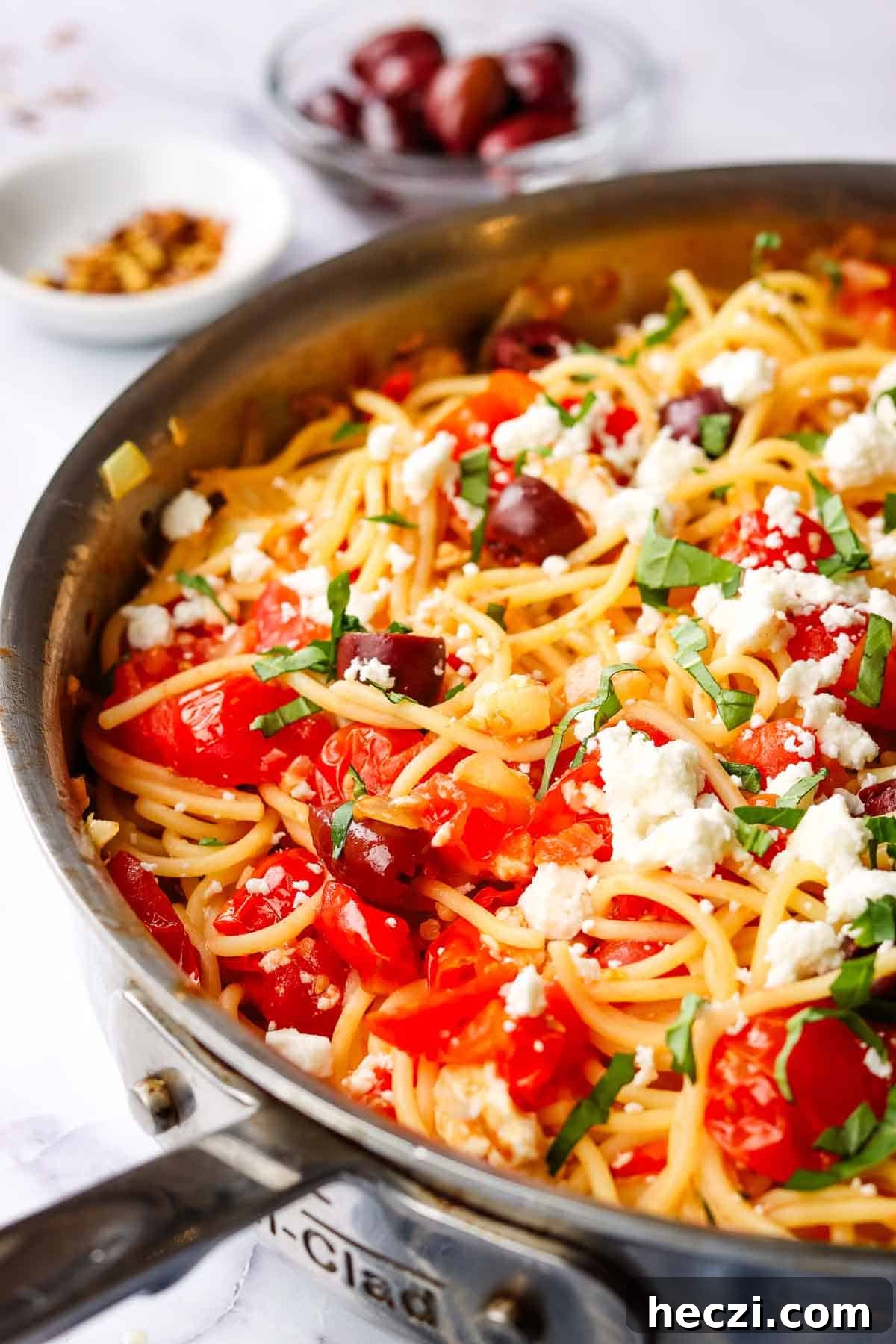 side view of greek spaghetti in a large skillet