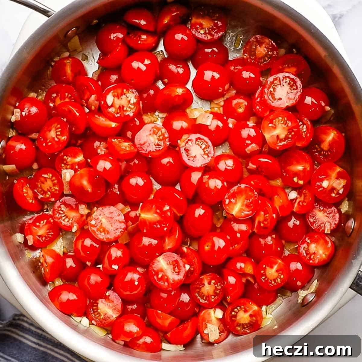 grape tomatoes cooking in the large skillet