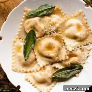 A cropped square image of butternut squash ravioli in a bowl with sage.