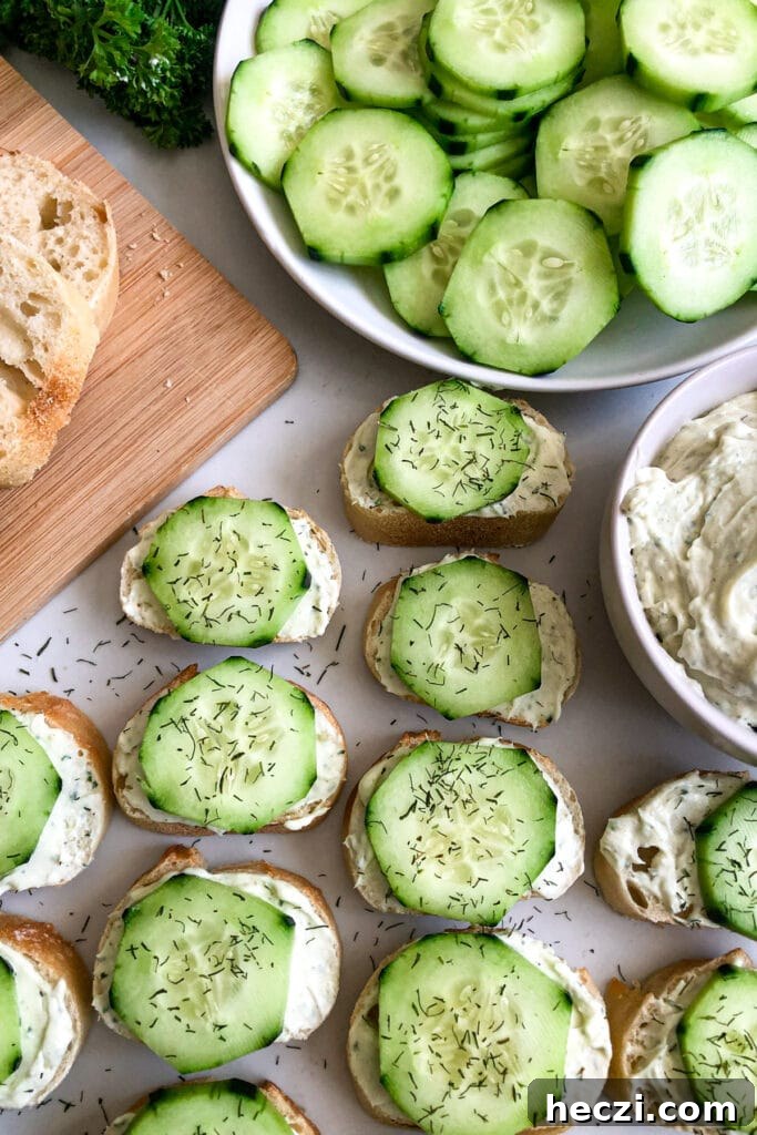 Dill and cucumber baguettes with sliced cucumbers and cream cheese spread in a bowl