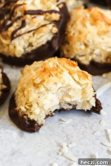 Coconut macaroon cookie with a bite taken out of it.