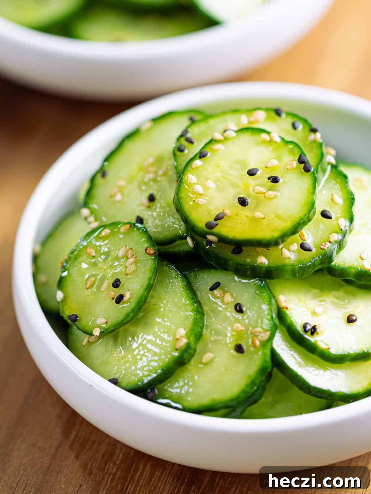 Sunomono or Japanese cucumber salad in a white bowl.