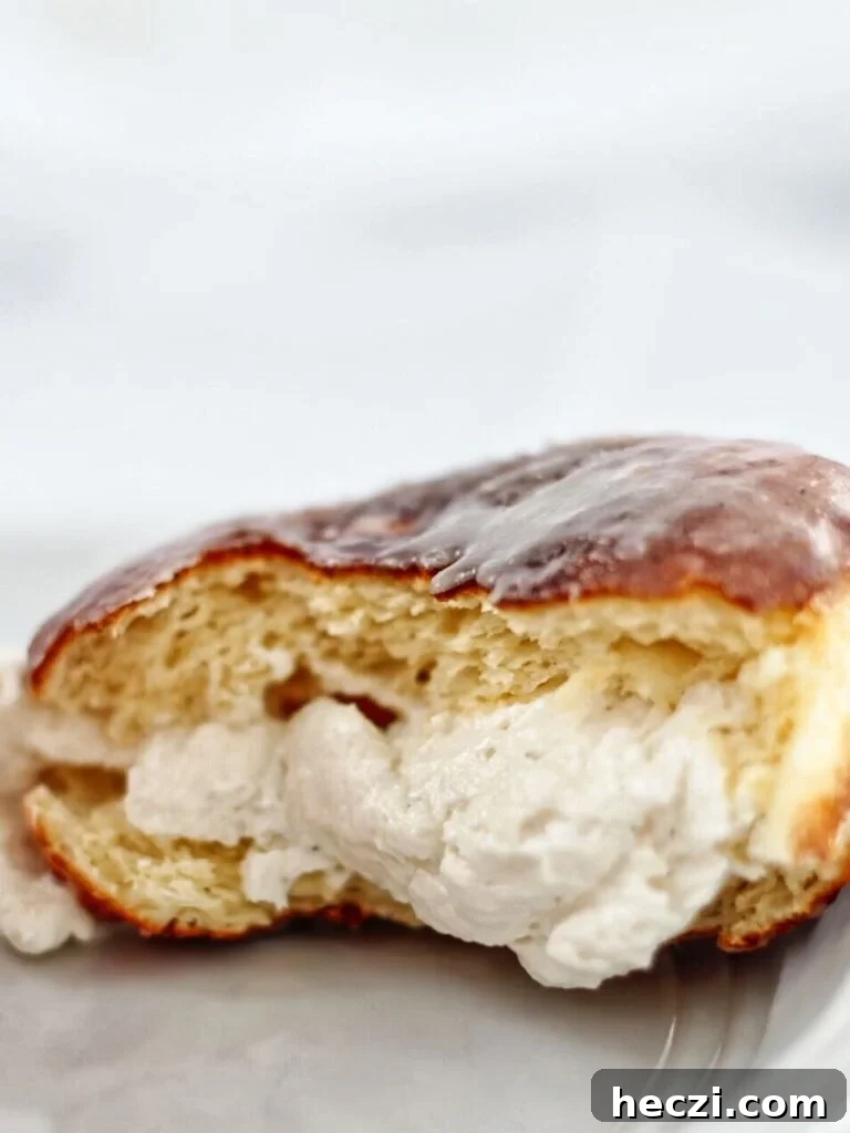 Light and Fluffy Gluten-Free Yeast Donuts Recipe 8 cream filled donut ripped open and up close on white plate.