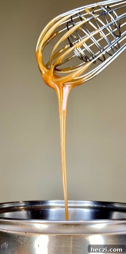 Fudgy Nutella Brownies with Salted Caramel Drizzle 11 Drizzle of caramel sauce from whisk to pot.