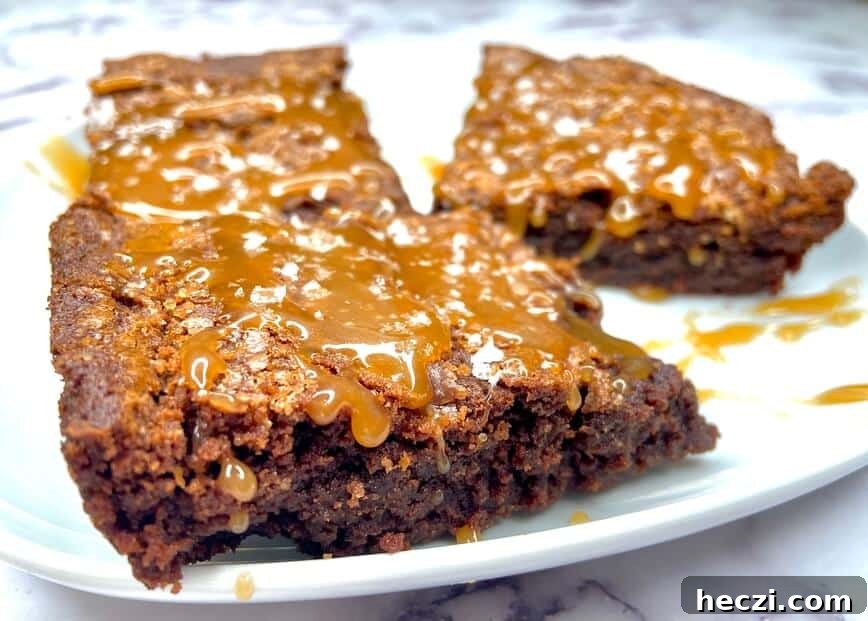 Fudgy Nutella Brownies with Salted Caramel Drizzle 5 Brownies with caramel sauce on top.