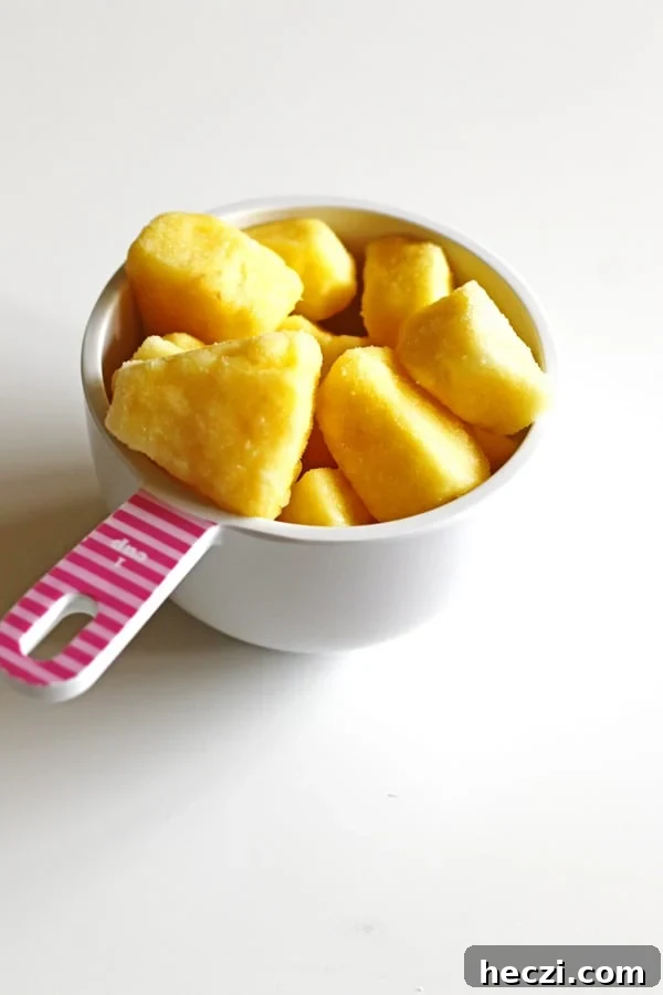 Refreshing Fruit Smoothie Recipes for Energy and Flavor 6 Frozen pineapple in a white measuring cup