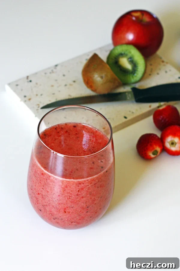 Refreshing Fruit Smoothie Recipes for Energy and Flavor 7 Smoothie with sliced fruit on cutting board with a knife
