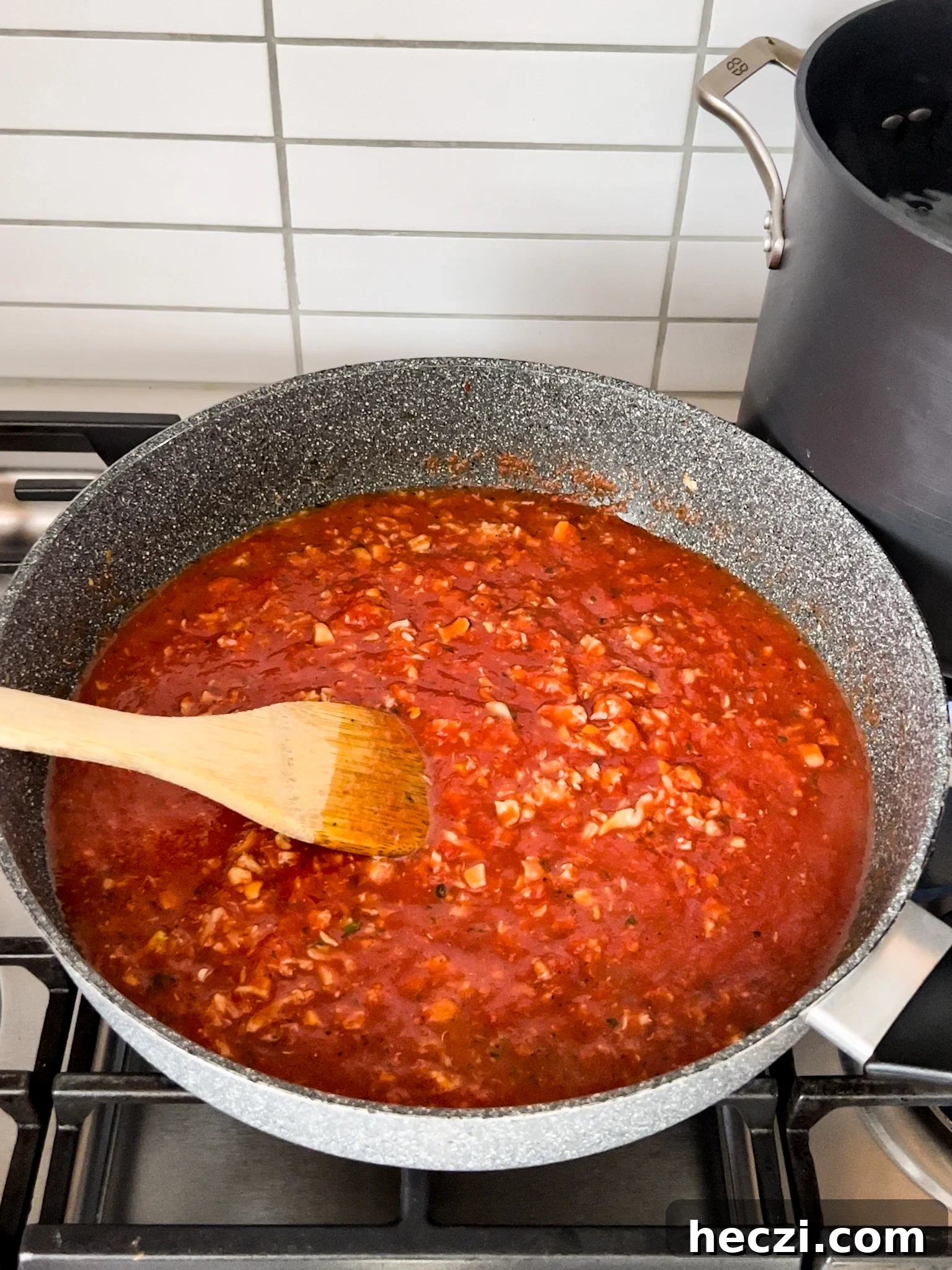 Red Clam Sauce Recipe for Pasta: Simple Italian-Style Sauce 8 A pan on a stove with sauce in it.