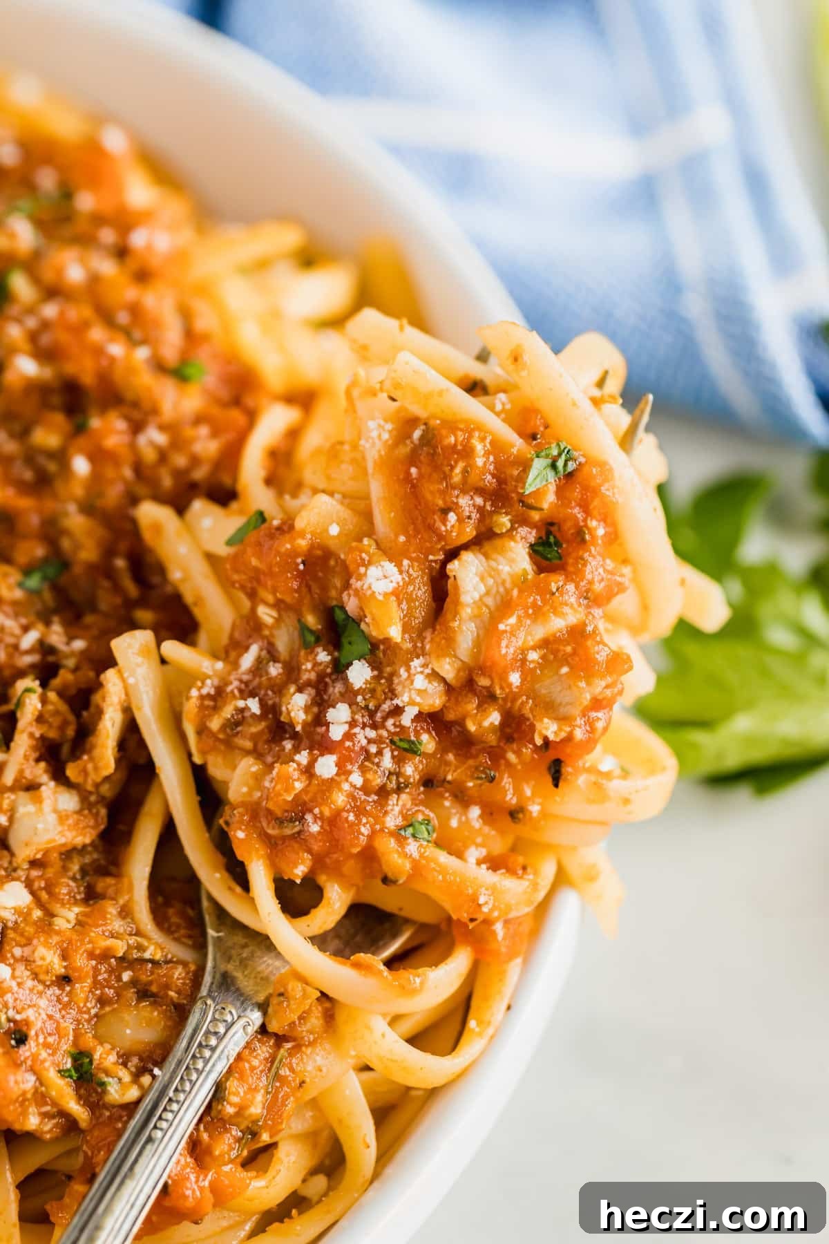 Red Clam Sauce Recipe for Pasta: Simple Italian-Style Sauce 10 A close up image of a fork with linguine and clam sauce twirled onto it.
