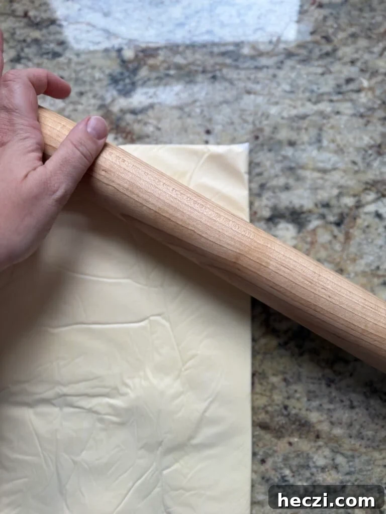 Top Gifts for Sourdough Bakers: 30+ Ideas They'll Love 19 Rolling pin flattening a butter block for laminated sourdough pastry.