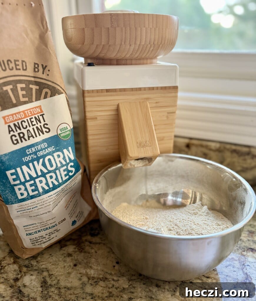Top Gifts for Sourdough Bakers: 30+ Ideas They'll Love 25 Grain mill next to a bag of whole grains and freshly milled flour.