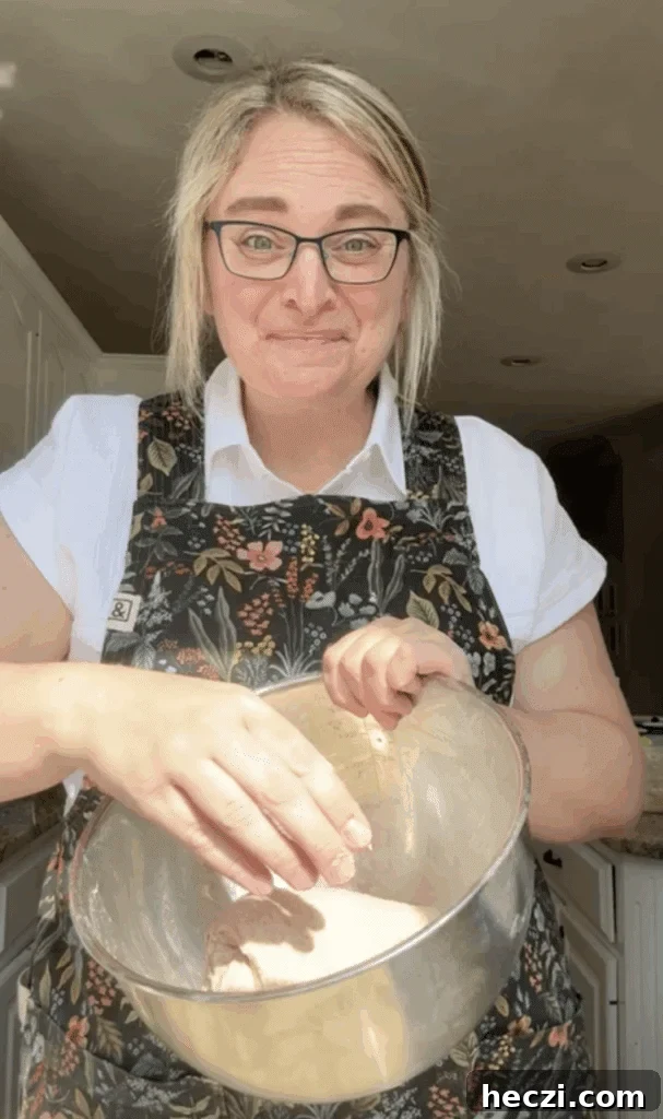 Top Gifts for Sourdough Bakers: 30+ Ideas They'll Love 28 Amy Coyne wearing a Hedley & Bennett apron while mixing sourdough bread dough.