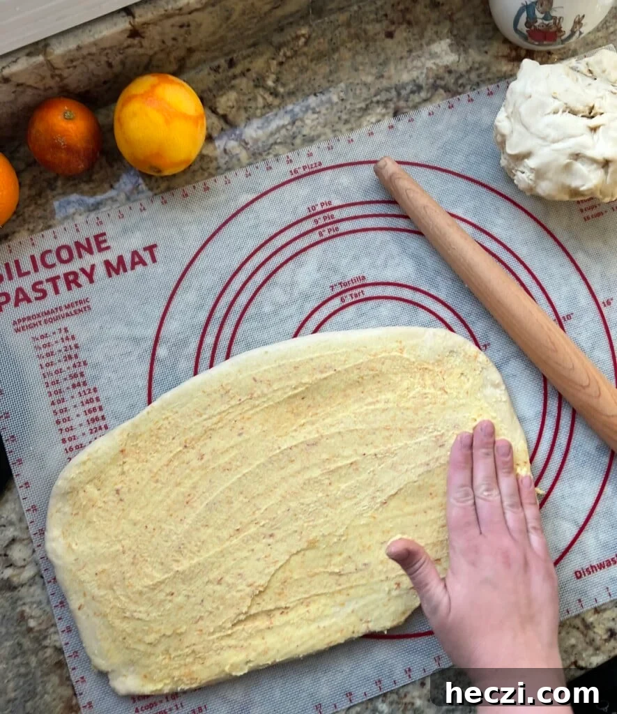 Top Gifts for Sourdough Bakers: 30+ Ideas They'll Love 31 Orange roll dough rolled out on pastry mat topped with filling