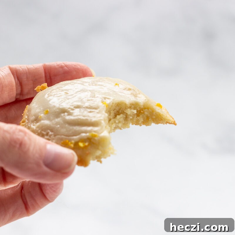 A keto lemon cookie with a bite taken out of it.