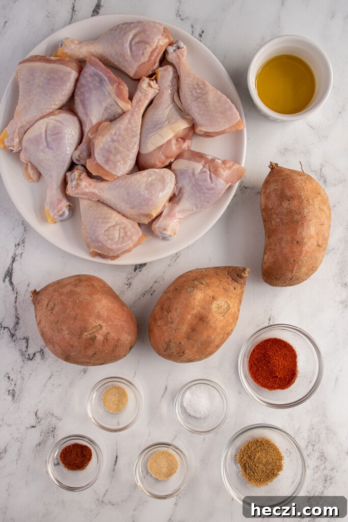 Sheet Pan Chicken Legs with Roasted Sweet Potatoes 4 Ingredients needed to make sheet pan chicken legs and sweet potatoes laid out on a tabletop.
