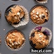 Blueberry Banana Oat Oatmeal Muffins for Breakfast 14 Healthy banana blueberry oatmeal muffins topped with rolled oats fresh out of the oven.