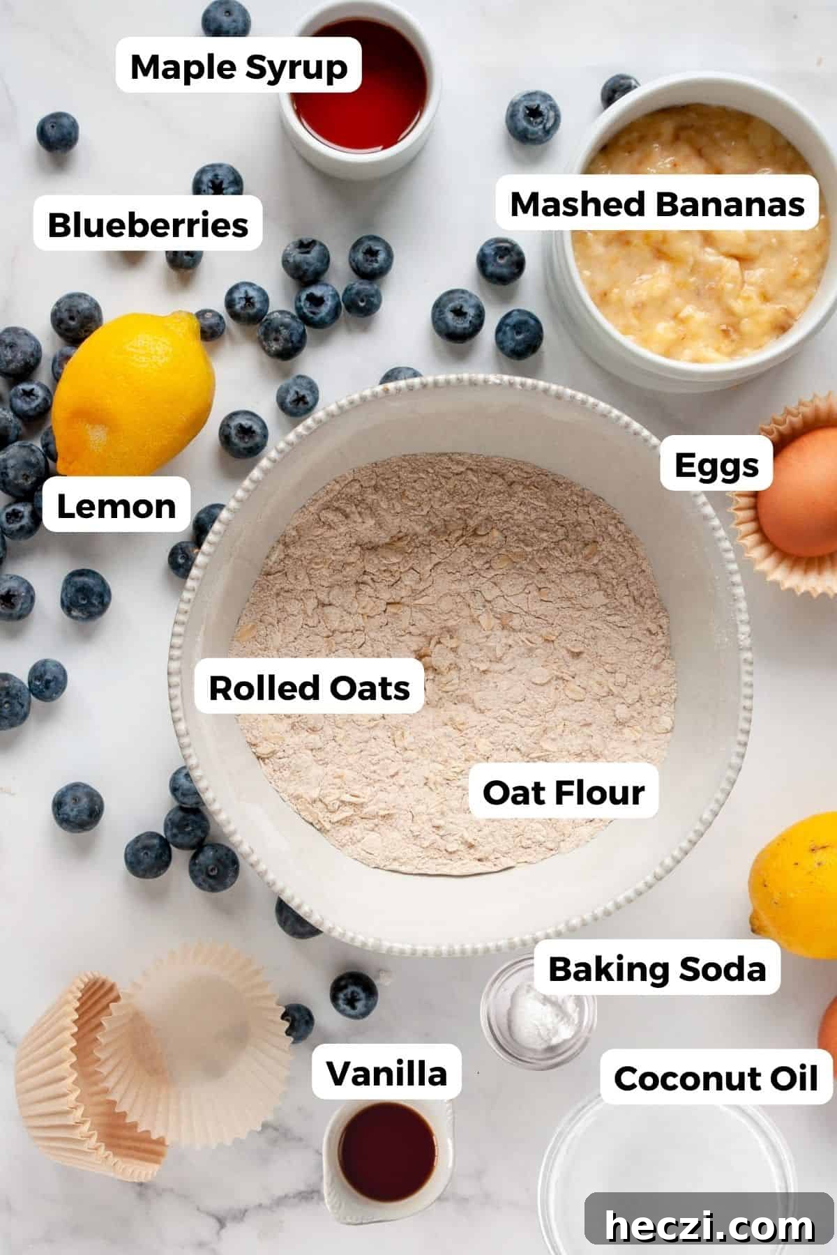 Blueberry Banana Oat Oatmeal Muffins for Breakfast 3 Ingredients for healthy banana blueberry oatmeal muffins including oat flour, rolled oats, blueberries, bananas, maple syrup, coconut oil, eggs and lemon.