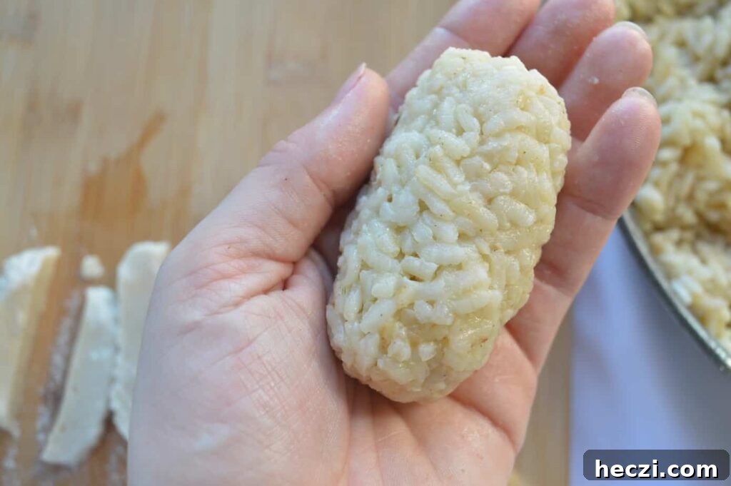 Vegan Supplì: How to Make Italy’s Crispy Fried Rice Balls 7 A rounded cylinder of risotto held in a hand