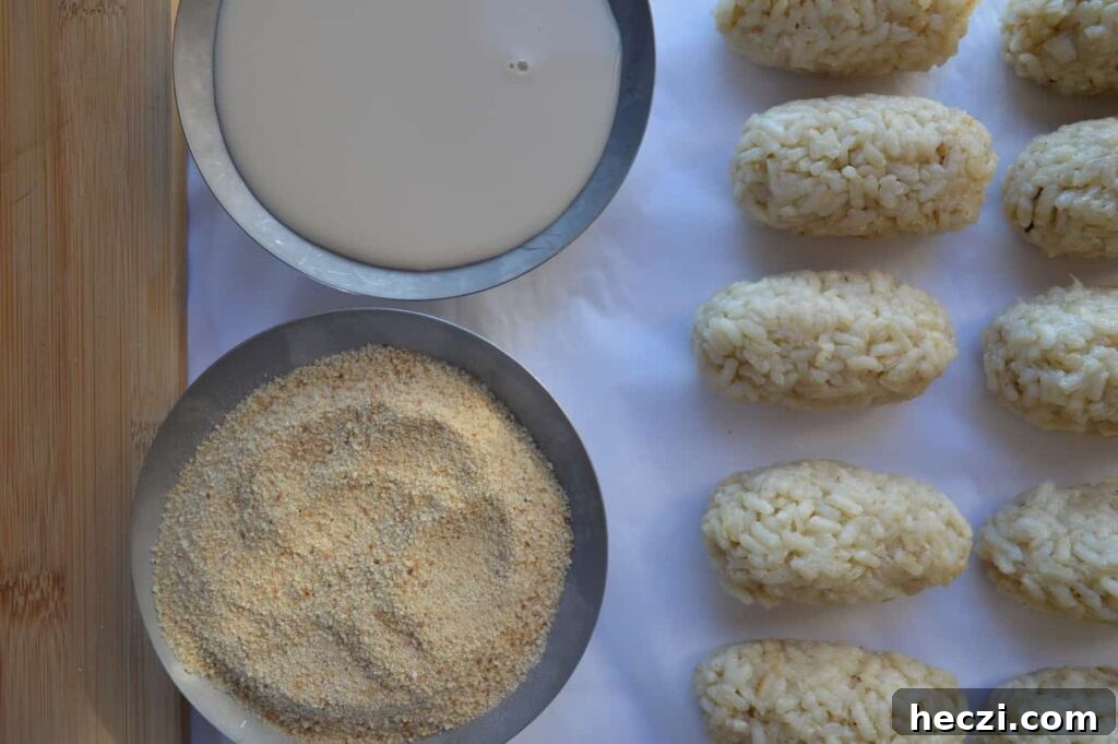 Vegan Supplì: How to Make Italy’s Crispy Fried Rice Balls 8 A bowl of milk, a bowl of breadcrumbs and five shaped rice croquettes