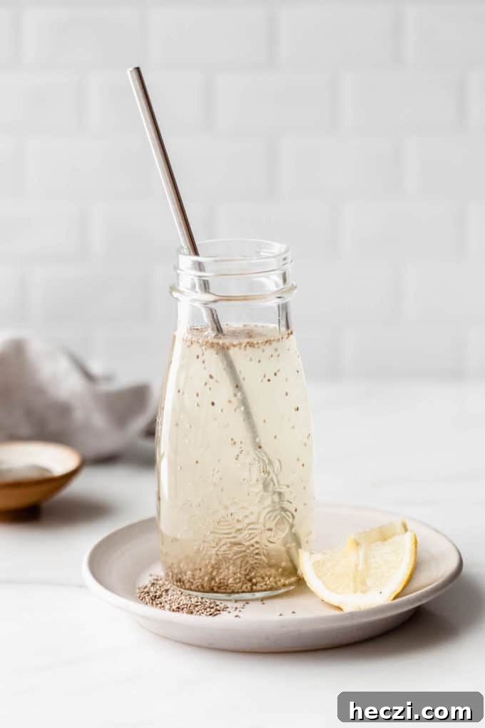 Chía Fresca: Refreshing Mexican Chia Drink Recipe 2 A chia fresca in a glass jar on a white plate with lemons on the side