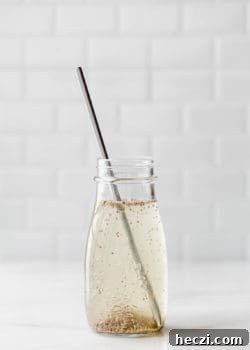 a chia seed drink in a jar with a metal straw