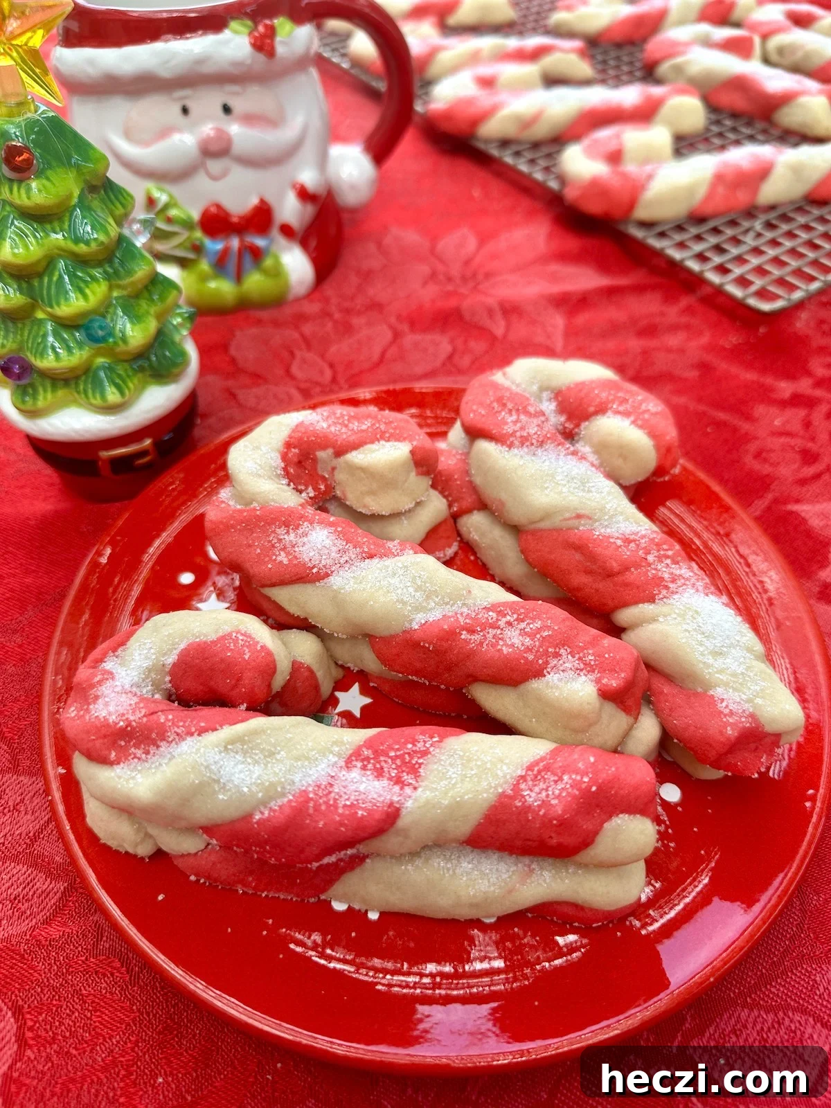 Peppermint Candy Cane Cookies Recipe for Festive Holidays 2 Candy cane cookies on a plate on a table.