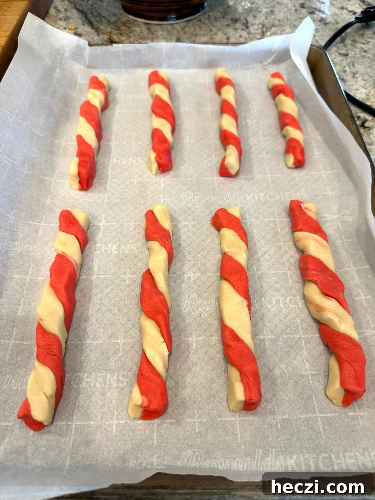 Peppermint Candy Cane Cookies Recipe for Festive Holidays 13 Candy cane cookies arranged on a baking sheet.