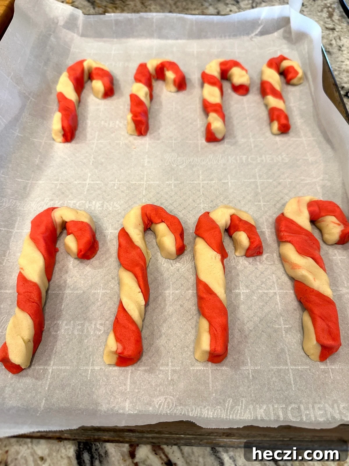 Peppermint Candy Cane Cookies Recipe for Festive Holidays 14 Unbaked candy cane cookies on a baking sheet.