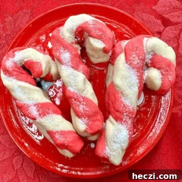 Peppermint Candy Cane Cookies Recipe for Festive Holidays 22 Candy cane cookies on a plate.
