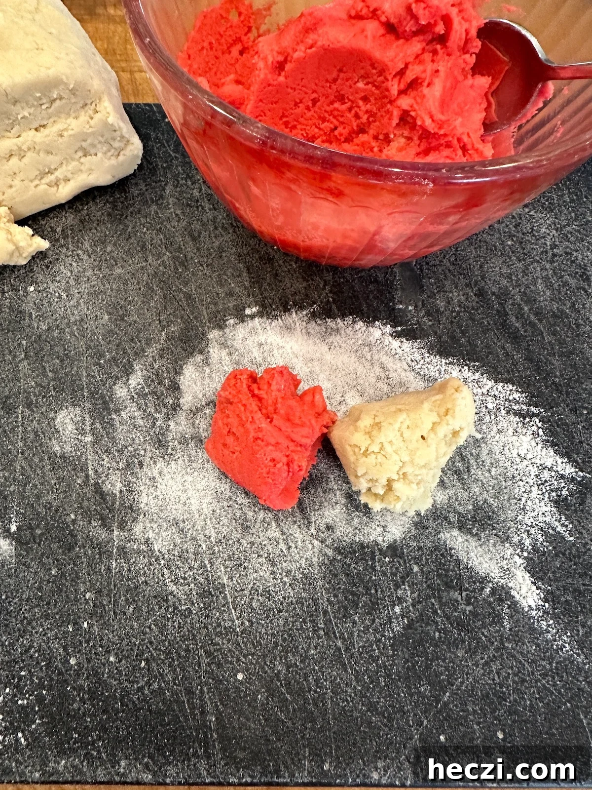 Peppermint Candy Cane Cookies Recipe for Festive Holidays 9 Two pieces of candy cane cookie dough on a cutting board.