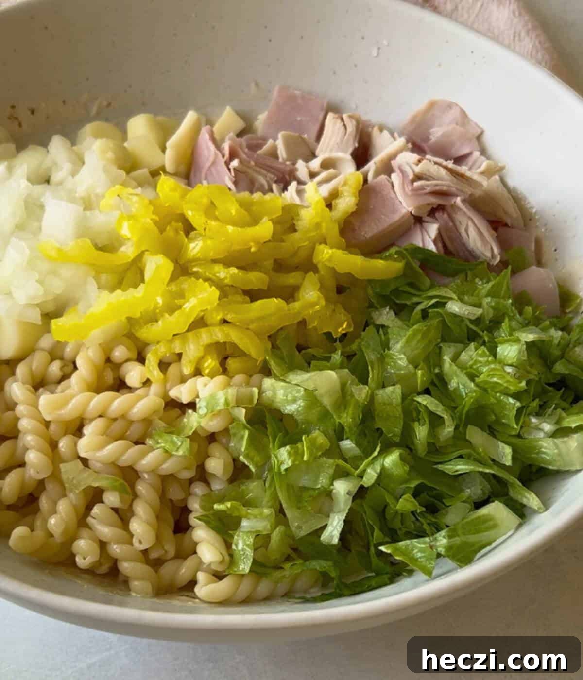 Ingredients for pasta salad in bowl.
