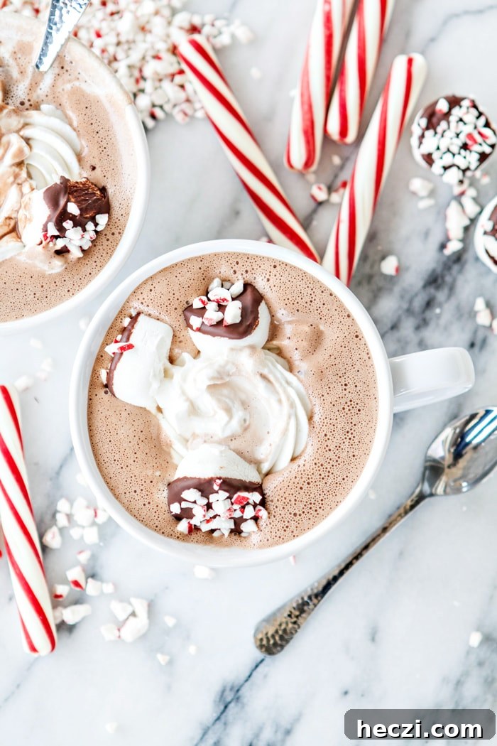 two mugs of spiked peppermint hot chocolate