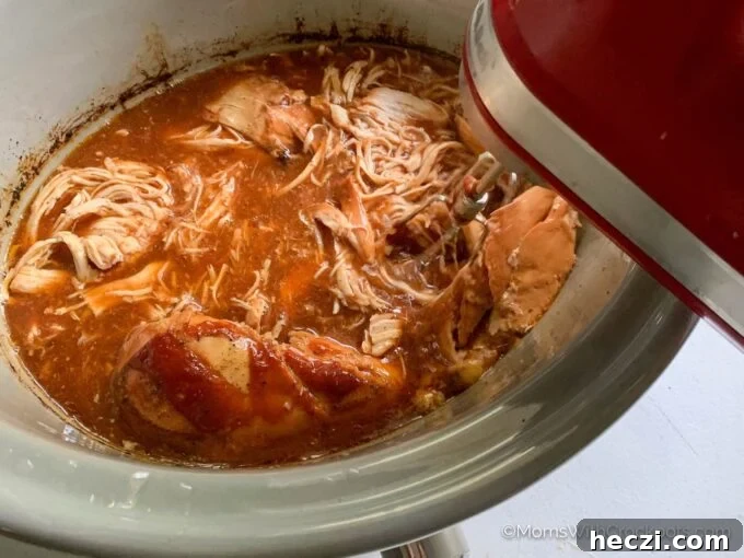 Crock Pot Pulled Chicken Recipe for Tender, Juicy Sandwiches 3 chicken in crockpot with mixer