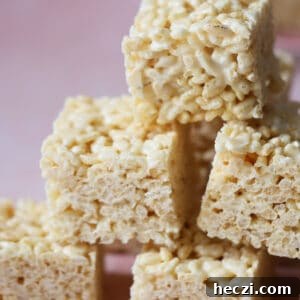 Gluten free rice krispies squares stacked on top of each other.